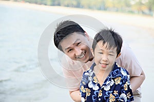 Father and son having fun on the beach. Conceptual image