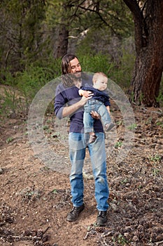 Father and son having fun in the forest