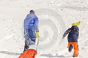 Father and son having fun in the snow