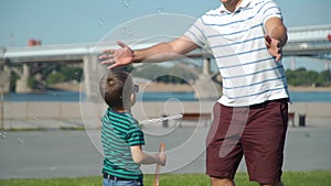 Father and Son Having Fun with Soap Bubbles