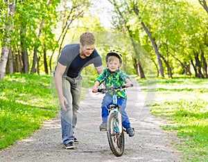Father and son having fun weekend biking