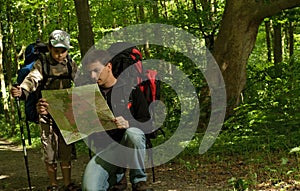 Father and son hiking in forest photo