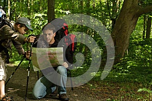 Father and son hiking in forest