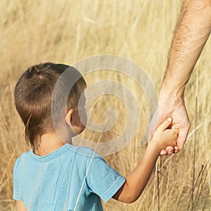 Father and son hold hands, hand in hand, effect of instagram