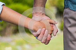 Father and son holding hands