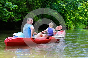 Father and son kayaking on the river