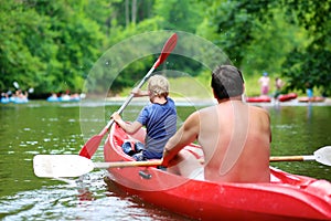 Father and son kayaking on the river