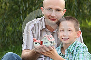 Father and son keeping in their hands wendy house