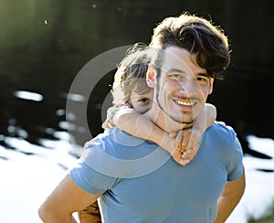 Father with son on lake, summer vacation