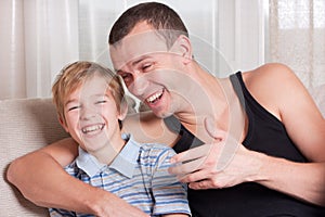 Father and son laugh.