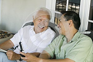 Father and son laughing outside home
