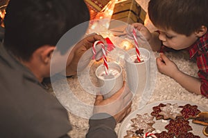 Father and son laying under christmas tree.