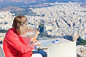 Father and son looking at Athens, Greece