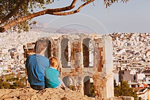 Father and son looking at Odeon in Acropolis, Athens, Greece