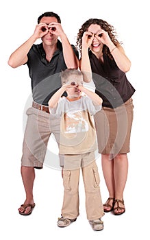 Father, son and mother look in field-glasses from