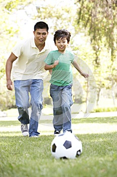 Father And Son In Park With Soccer Ball