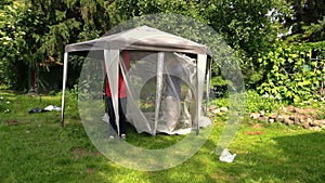 Father and son people attach protective tent bower net in garden