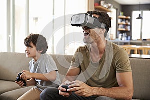 Father And Son Play Computer Game Using Virtual Reality Headset