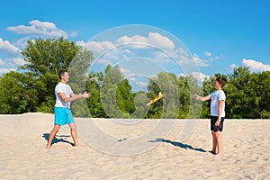 Father and son play with a toy airplane on the beach on a sunny day. Vacation sports games, vacation, sports, lifestyle