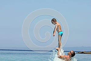 Father and son play in water