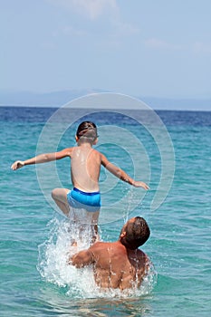 Father and son play in water