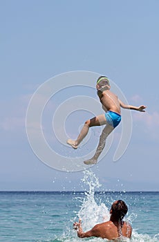 Father and son play in water