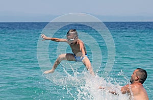 Father and son play in water