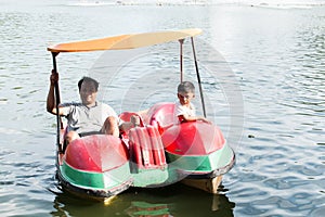Father and son play water bike boat