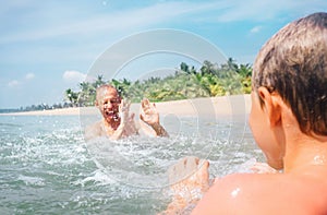 Father and son play in water together