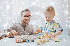 Father and son playing with ball clay at home