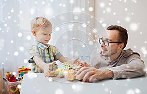 Father and son playing with ball clay at home