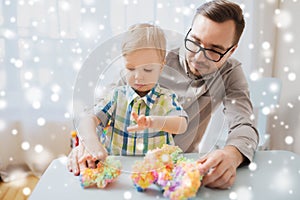 Father and son playing with ball clay at home