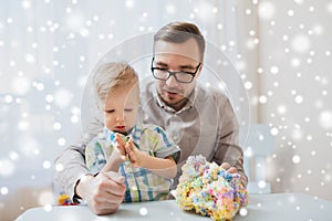 Father and son playing with ball clay at home