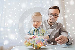 Father and son playing with ball clay at home