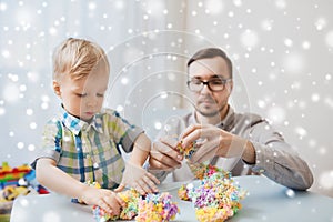 Father and son playing with ball clay at home