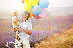 Father and son playing with balloons on lavender field