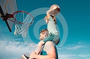 Father and son playing basketball. Dad and child spending time together.