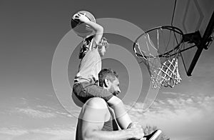 Father and son playing basketball. Dad and child spending time together.