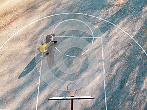 Father and son playing basketball in the park