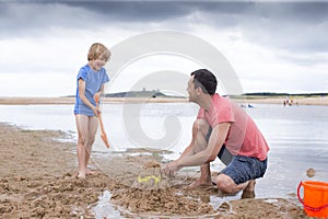 Father and son playing on the beach