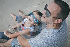 Father and son playing on the beach at the day time