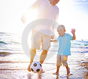 Father Son Playing Beach Football Happiness Concept