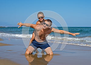 Father and Son Playing on the Beach, Having Quality Family Time Together. Greece.