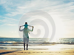 A un hijo sobre el Playa sobre el atardecer 