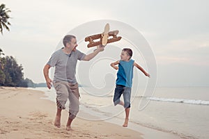 Father and son playing with cardboard toy airplane