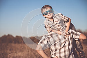 Father and son playing on the field at the day time