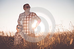 Father and son playing on the field at the day time