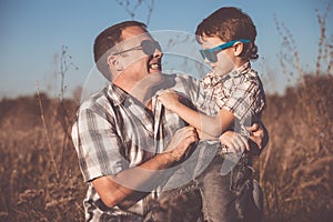 Father and son playing on the field at the day time