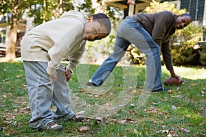 Father and son playing football