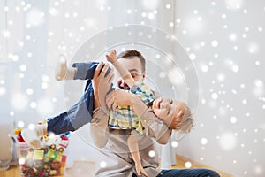 Father with son playing and having fun at home